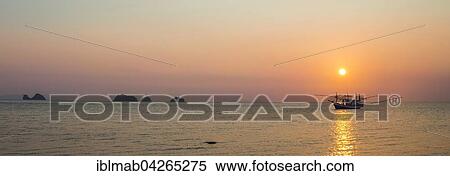 Boat in the sea at sunset in front of small islands, Koh Samui, Gulf of Thailand, Thailand, Asia View Large Photo Image Stock Photography - Boat in the sea at sunset in front of small islands, Koh Samui, Gulf of Thailand, Thailand, Asia. Fotosearch