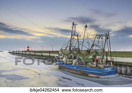 Boats in the harbour, ice on the water, Kleiner Preusse lighthouse behind, Wadden Sea, Wremen, Lower Saxony, Germany, Europe View Large Photo Image Picture - Boats in the harbour, ice on the water, Kleiner Preusse lighthouse behind, Wadden Sea, Wremen, Lower Saxony, Germany, Europe. Fotosearch