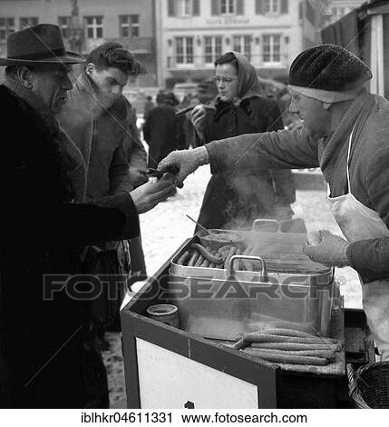 Bockwurst salesman in winter on a street in Freiburg, ca. 1955, Freiburg, Germany, Europe View Large Photo Image Stock Image - Bockwurst salesman in winter on a street in Freiburg, ca. 1955, Freiburg, Germany, Europe. Fotosearch