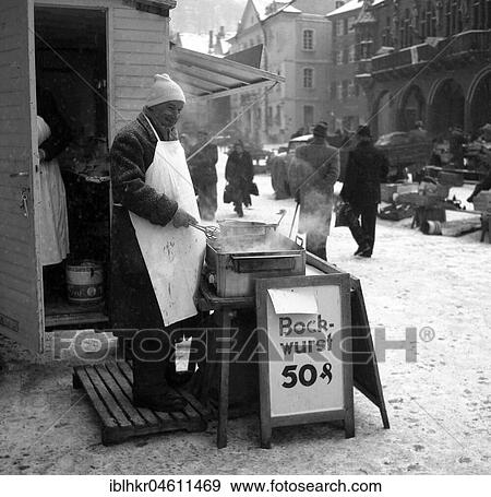 Bockwurst salesman in winter on a street in Freiburg, ca. 1955, Freiburg, Germany, Europe View Large Photo Image Stock Photo - Bockwurst salesman in winter on a street in Freiburg, ca. 1955, Freiburg, Germany, Europe. Fotosearch