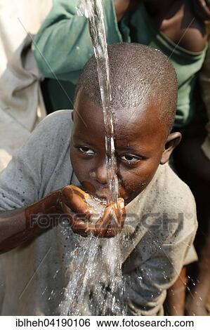 Stock Photograph - Boy drinking water, Matamba-Solo, Bandundu Province, Congo-Brazzaville, Africa. Fotosearch