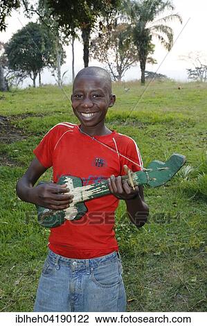 Boy playing on a home-built guitar, Matamba-Solo, Bandundu Province, Congo-Brazzaville, Africa View Large Photo Image Stock Image - Boy playing on a home-built guitar, Matamba-Solo, Bandundu Province, Congo-Brazzaville, Africa. Fotosearch