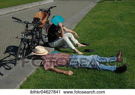 Break, cyclists sunbathe in the park, Germany, Europe View Large Photo Image Stock Image - Break, cyclists sunbathe in the park, Germany, Europe. Fotosearch