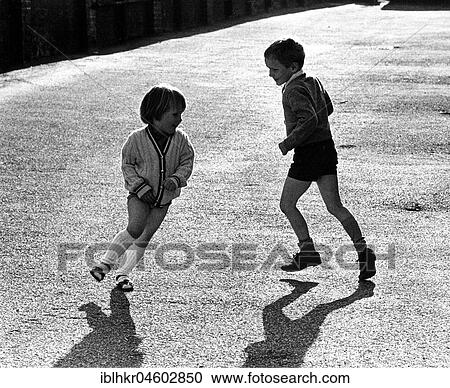 Stock Image - Brother and sister play together, England, Great Britain. Fotosearch