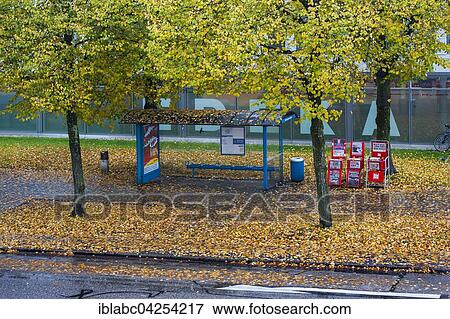Bus stop with autumn leaves, Munich, Bavaria, Germany, Europe View Large Photo Image Stock Photo - Bus stop with autumn leaves, Munich, Bavaria, Germany, Europe. Fotosearch