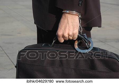 Businessman with handcuffs on bag and wrist, Germany, Europe View Large Photo Image Stock Image - Businessman with handcuffs on bag and wrist, Germany, Europe. Fotosearch