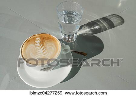 Cappuccino, glass of water, shadows View Large Photo Image Stock Photo - Cappuccino, glass of water, shadows. Fotosearch