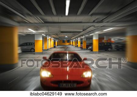 Stock Photo - Car drives in underground garage, Germany, Europe. Fotosearch