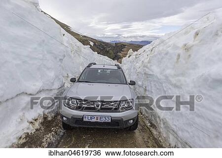 Stock Photograph - Car driving to the hot spring area Hveradalir through snow, Kerlingarfjöll, Suðurland, Iceland, Europe. Fotosearch