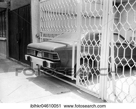 Stock Image - Car sticks out through fence, too small parking lot, Mexico City, Mexico, Central America. Fotosearch