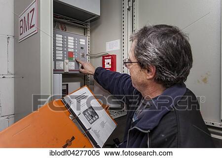 Caretaker servicing the central fire alarm system, BMZ View Large Photo Image Stock Photography - Caretaker servicing the central fire alarm system, BMZ. Fotosearch