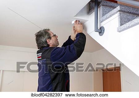 Caretaker with smoke detector in a stairwell, Dusseldorf, North Rhine-Westphalia, Germany, Europe View Large Photo Image Stock Photo - Caretaker with smoke detector in a stairwell, Dusseldorf, North Rhine-Westphalia, Germany, Europe. Fotosearch