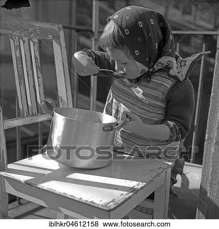 Child slurps out of a pot, Freiburg and surrounding area approx. 1945 to 1955 View Large Photo Image Stock Photo - Child slurps out of a pot, Freiburg and surrounding area approx. 1945 to 1955. Fotosearch