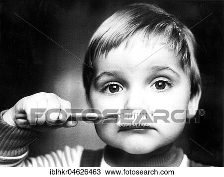 Stock Image - Child with toothbrush, ca. 1980s, East Berlin, GDR, Germany, Europe. Fotosearch