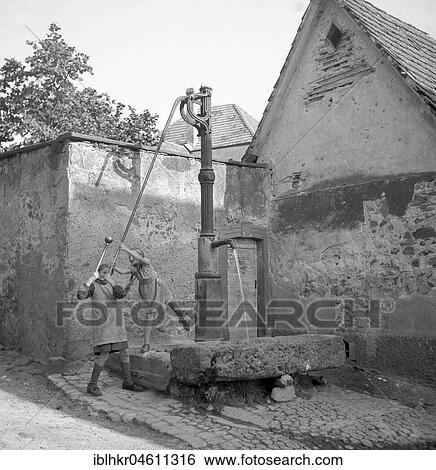 Children at the fountain, ca. 1955, around Freiburg, Germany, Europe View Large Photo Image Stock Photograph - Children at the fountain, ca. 1955, around Freiburg, Germany, Europe. Fotosearch