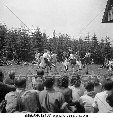 Children dance in a meadow, parents watch them, around Freiburg from 1945 to 1955 View Large Photo Image Stock Photo - Children dance in a meadow, parents watch them, around Freiburg from 1945 to 1955. Fotosearch