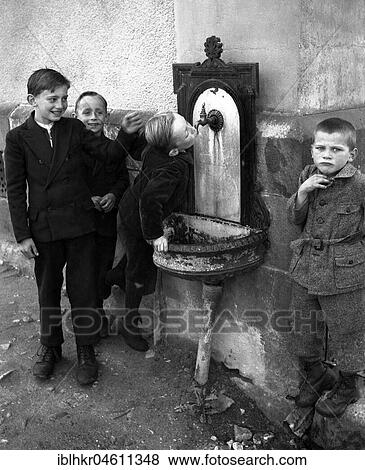 Children drink from Brunnen, ca. 1955, Freiburg, Germany, Europe View Large Photo Image Stock Photo - Children drink from Brunnen, ca. 1955, Freiburg, Germany, Europe. Fotosearch