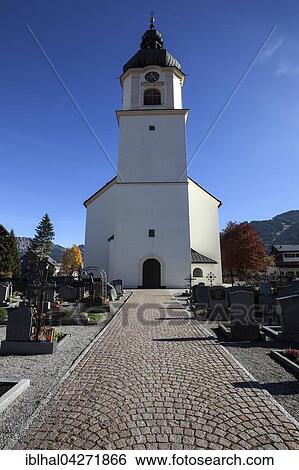 Stock Photograph - Church, St. Nicholas Parish Church with cemetery, exterior, Tannheim, Tannheim Valley, Tyrol, Austria, Europe. Fotosearch