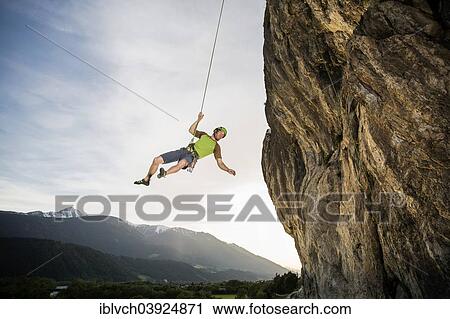 Stock Image - Climber hanging on the rope by the cliff, Martinswand, Zirl, Tyrol, Austria, Europe. Fotosearch