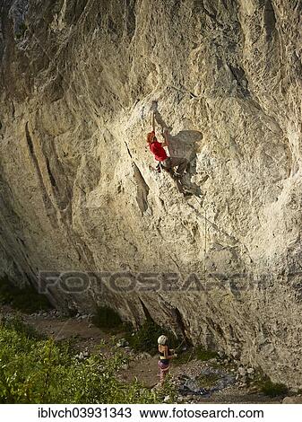 Stock Image - Climber lead climbing on a rock face, Martinswand, Zirl, Tyrol, Austria, Europe. Fotosearch