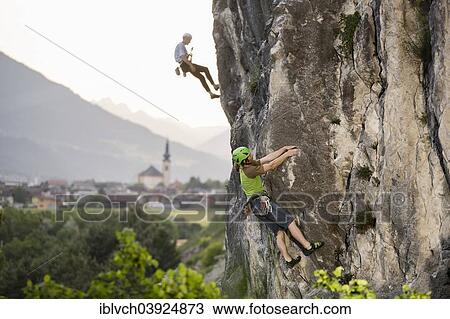 Climber lead climbing on a rock wall, climber abseiling behind, Zirl behind, Martinswand, Tyrol, Austria, Europe View Large Photo Image Stock Image - Climber lead climbing on a rock wall, climber abseiling behind, Zirl behind, Martinswand, Tyrol, Austria, Europe. Fotosearch