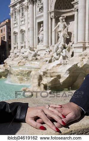 Couple holding hands just engaged, Trevi fountain, Rome, Italy, Europe View Large Photo Image Stock Image - Couple holding hands just engaged, Trevi fountain, Rome, Italy, Europe. Fotosearch