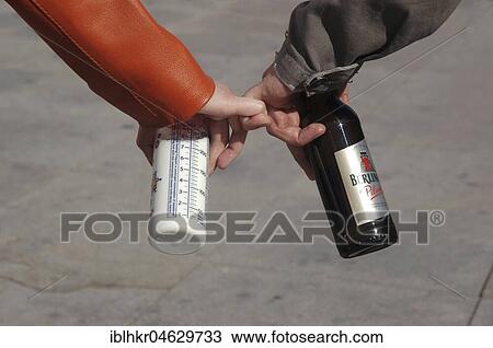 Stock Image - Couples with hooked fingers, beer bottle and baby milk bottle, Berlin, Germany, Europe. Fotosearch