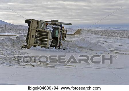 Picture - Dempster Highway, year-round cleared gravel road, overturned truck, Yukon, Canada, North America. Fotosearch