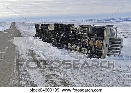 Stock Photo - Dempster Highway, year-round cleared gravel road, overturned truck, Yukon, Canada, North America. Fotosearch