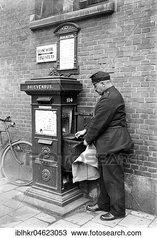 Stock Image - Dutch postman teaches the mailbox, ca. 1930, exact place unknown, Netherlands. Fotosearch