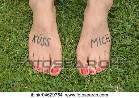 Picture - Feet of a woman with the writing kiss me, Germany, Europe. Fotosearch