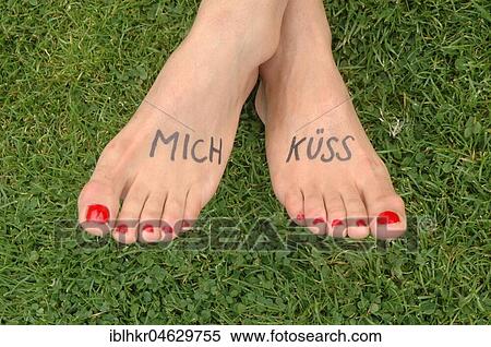 Stock Photography - Female feet with the writing kiss me, Germany, Europe. Fotosearch
