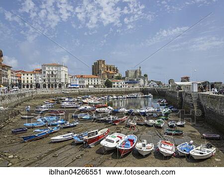 Stock Image - Fishing boats in the harbor at low tide, Castro Urdiales, Cantabria, Spain, Europe. Fotosearch