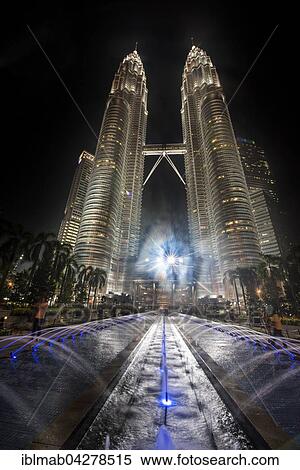 Stock Photography - Fountain in front of illuminated Petronas Towers at night, Kuala Lumpur, Malaysia, Asia. Fotosearch