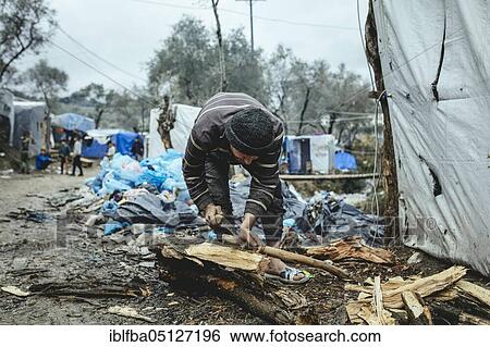 Fugitive in camp chopping firewood, Moria, Lesbos, Greece, Europe View Large Photo Image Stock Photograph - Fugitive in camp chopping firewood, Moria, Lesbos, Greece, Europe. Fotosearch