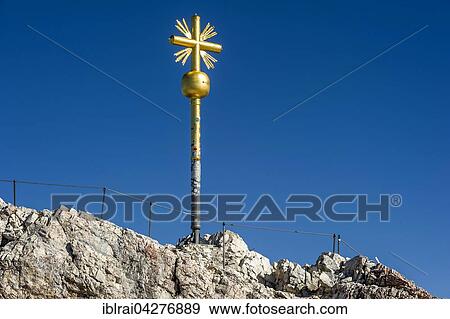 Stock Photo - Gilded summit cross, Zugspitze, Garmisch-Partenkirchen, Wetterstein, Eastern Alps, Upper Bavaria, Bavaria, Germany, Europe. Fotosearch