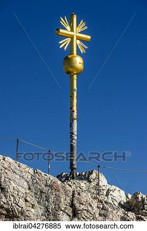 Gilded summit cross, Zugspitze, Garmisch-Partenkirchen, Wetterstein, Eastern Alps, Upper Bavaria, Bavaria, Germany, Europe View Large Photo Image Stock Photography - Gilded summit cross, Zugspitze, Garmisch-Partenkirchen, Wetterstein, Eastern Alps, Upper Bavaria, Bavaria, Germany, Europe. Fotosearch