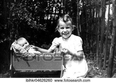 Girl playing with baby doll, ca. 1955, Leipzig, Germany, Europe View Large Photo Image Stock Image - Girl playing with baby doll, ca. 1955, Leipzig, Germany, Europe. Fotosearch