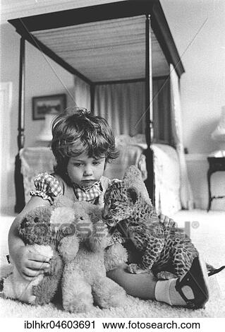 Girl plays with a baby predator and stuffed animals, England, Great Britain View Large Photo Image Stock Image - Girl plays with a baby predator and stuffed animals, England, Great Britain. Fotosearch