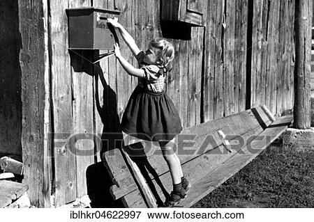 Girl trying to reach mailbox, ca. 1930, exact place unknown, Germany, Europe View Large Photo Image Stock Photo - Girl trying to reach mailbox, ca. 1930, exact place unknown, Germany, Europe. Fotosearch