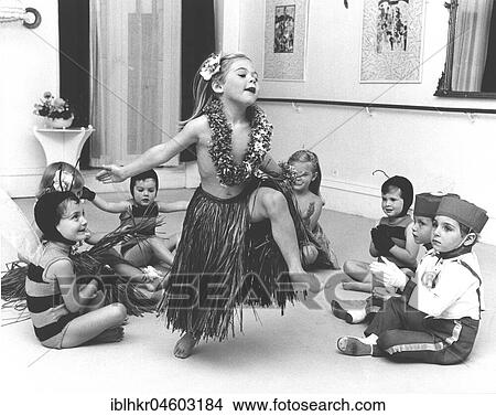 Picture - Girl with raffia skirt dances, dressep up children clap, England, Great Britain. Fotosearch