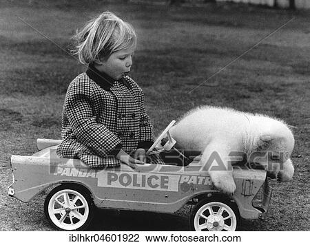 Stock Image - Girls and bears in a toy car, England, Great Britain. Fotosearch