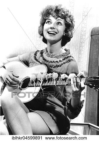 Stock Image - Guitarist and white mice, England, Great Britain. Fotosearch