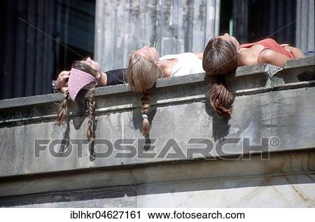 Stock Image - Hair of sunny women hanging down wall, Berlin, Germany, Europe. Fotosearch