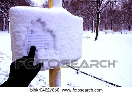 Hand points to snowy timetable, Germany, Europe View Large Photo Image Stock Photo - Hand points to snowy timetable, Germany, Europe. Fotosearch