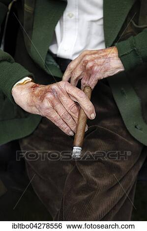 Stock Photograph - Hands of a very old man with cigar, corduroy pants and jacket, retirement home, Berlin, Germany, Europe. Fotosearch