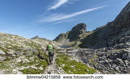 Stock Photo - Hiker on a path, Klafferkessel with small mountain lakes, Oberer Klaffersee, Greifenberg, Rohrmoos-Untertal, Schladming Tauern, Styria, Austria, Europe. Fotosearch