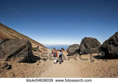 Stock Photo - Hikers on footpath to the Huevos del Teide, volcanic landscape, Teide-Nationalpark, Tenerife, Spain, Europe. Fotosearch