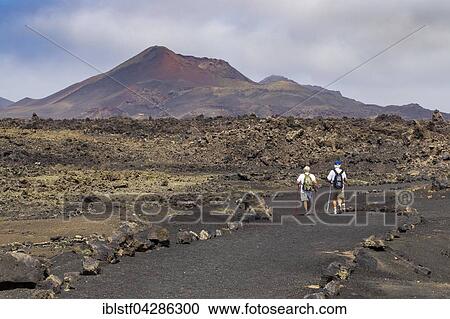 Stock Image - Hiking trail through volcanic landscape, Montana del Cuervo, Lanzarote, Canary Islands, Spain, Europe. Fotosearch