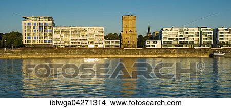 Picture - Houses with Bayenturm defence tower by the river Rhein, Rheinauhafen, Cologne, North Rhine-Westphalia, Germany, Europe. Fotosearch